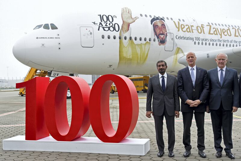 Tom Enders, CEO of Airbus (C), Sheikh Ahmed bin Saeed Al Maktoum, Emirates' chairman and CEO (L) and Tim Clark President Emirates Airlines, pose for media during a delivery ceremony of Emirates' 100th Airbus A380 at the German headquarters of aircraft company Airbus in Hamburg-Finkenwerder, November 3, 2017. REUTERS/Fabian Bimmer