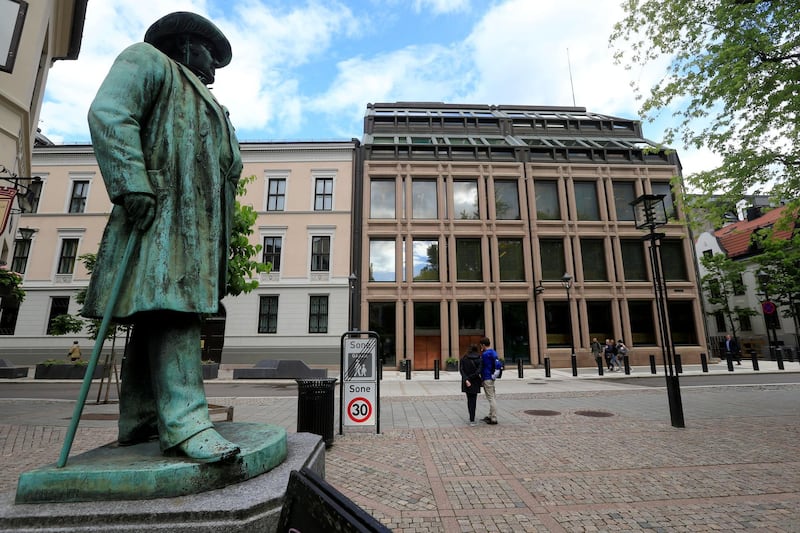 FILE PHOTO: People go about their day near Norway's central bank building in Oslo, Norway May 31, 2017. REUTERS/Ints Kalnins/File Photo