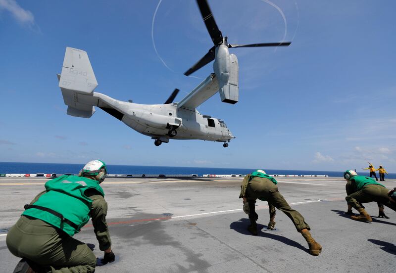 Flight deck crew aboard the USS Kearsarge aircraft carrier brace themselves from the propeller wash of a departing MV-22B Osprey in the service of the Marine Corps as US military continues to evacuate from the US Virgin Islands in advance of Hurricane Maria. Jonathan Drake / Reuters