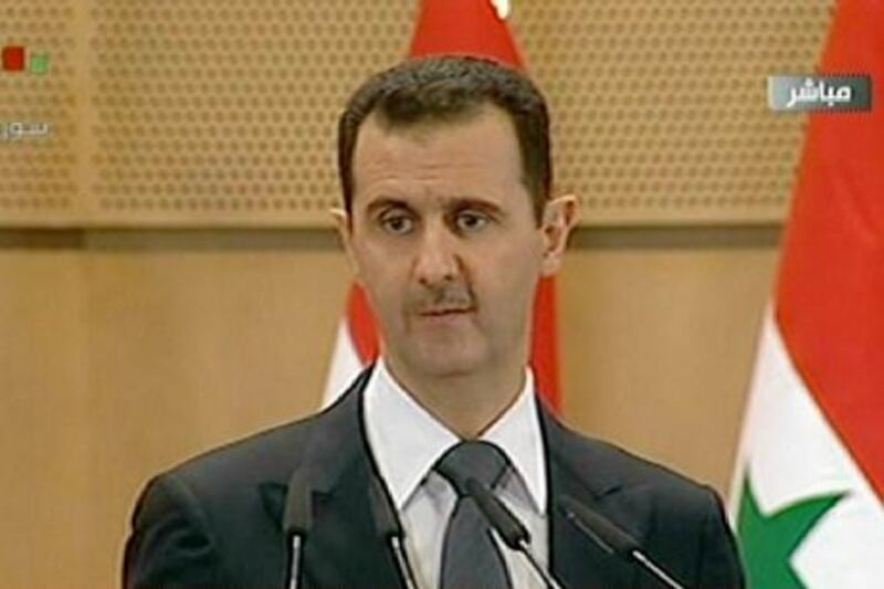 RESTRICTED TO EDITORIAL USE - MANDATORY CREDIT "AFP PHOTO / SYRIAN TV" - NO MARKETING NO ADVERTISING CAMPAIGNS - DISTRIBUTED AS A SERVICE TO CLIENTS
An image grab taken from Syrian state television shows Syrian President Bashar al-Assad addressing the nation from Damascus University in the Syrian capital on June 20, 2011. AFP PHOTO/SYRIAN TV
 *** Local Caption ***  252971-01-08.jpg