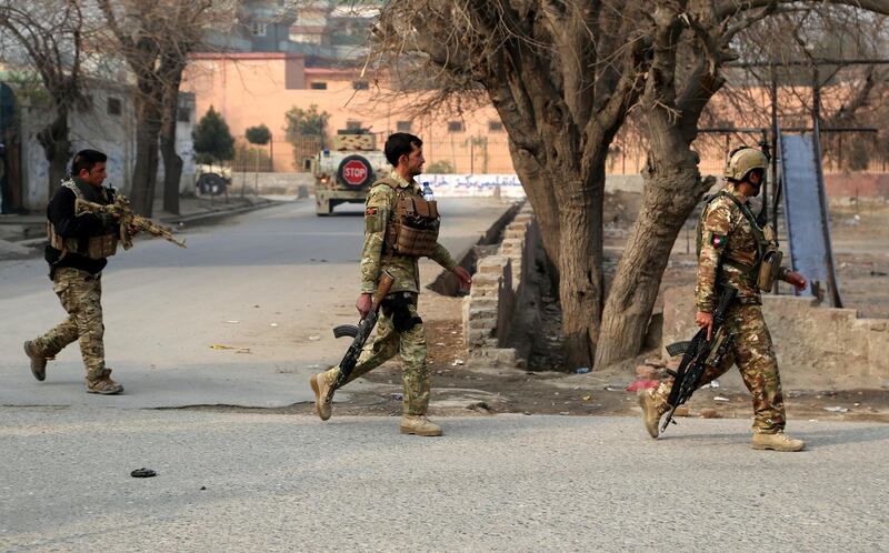 Afghan security officials hold a position after an attack on a Save the Children office in Jalalabad. Ghulamullah Habibi / EPA