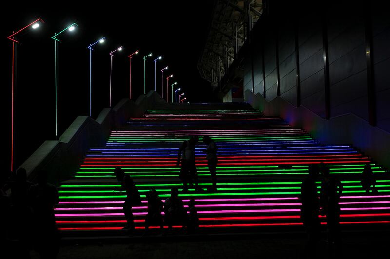 People enjoy stairs with coloured lights at a baseball stadium in La Guaira, Venezuela, amid the coronavirus pandemic. AP