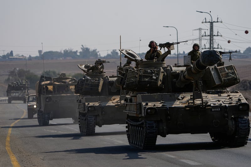Israeli armoured personnel carriers and tanks move towards the country's southern border. AP