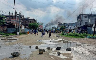 Crowds and security forces face each other during street clashes in Manipur on Thursday. AFP