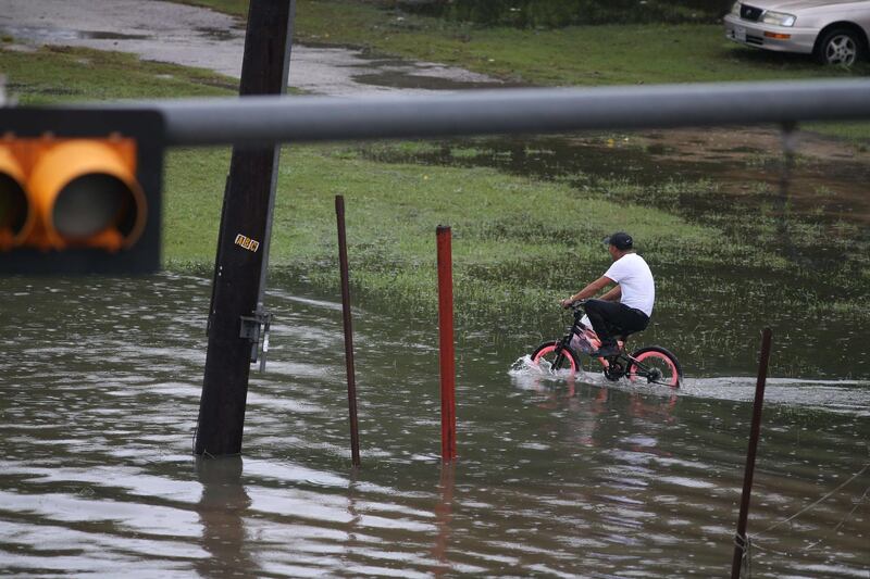 A boy on a bike rides in the flooded waters on Hopper Rd. on September 19, 2019 in Houston, Texas. Getty Images
