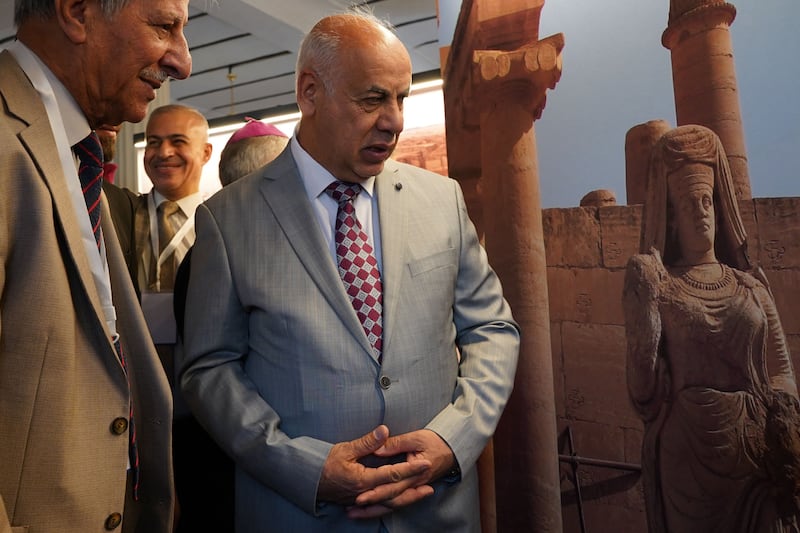 Ahmed Fakak al-Badrani, Iraqi Minister of Culture, Tourism and Antiquities, tours an exhibit at the Mosul Museum. AFP