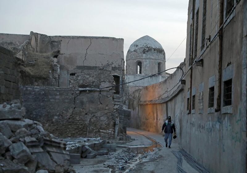 A man walks near the Church of Saint Thomas, in the Old City of Mosul, Iraq October 28, 2020. Picture taken October 28, 2020. REUTERS/Abdullah Rashid