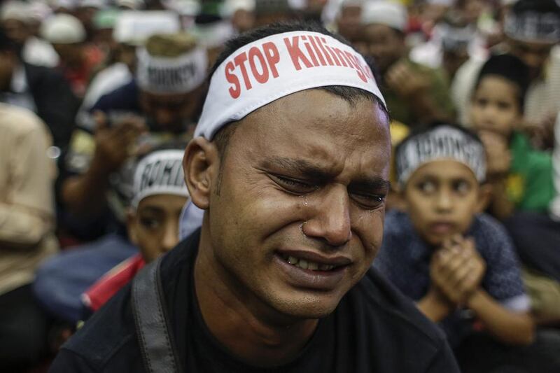  A Rohingya man cries as he prays during a protest condemning Myanmar's government violence on his people. Fazry Ismail / EPA