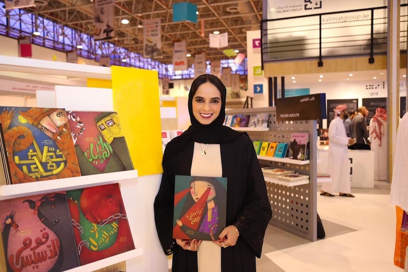 Dubai Abulhoul with a copy of 'Um Hailan', which she launched at the Sharjah International Book Fair. Courtesy Kalimat Group