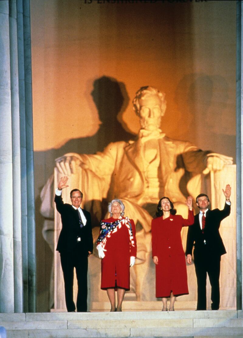 At the Lincoln Memorial, US President-Elect George HW Bush (left) and Vice President-Elect Dan Quayle (right), along with their wives, Barbra Bush (center left) and Marilyn Quayle, wave during their inaugural opening ceremony, Washington DC, January 18, 1989. (Photo by Robert Trippett/Consolidated News Pictures/Getty Images)