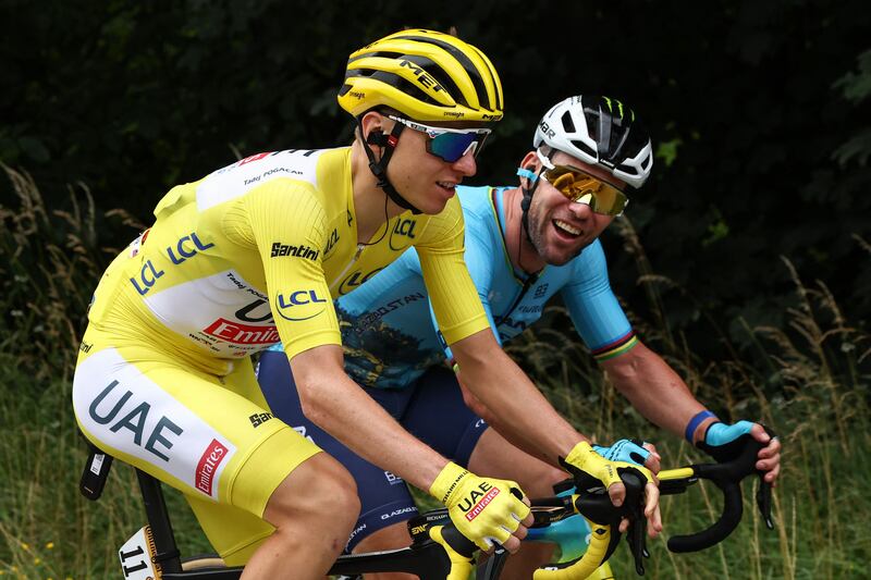 UAE Team Emirates rider Tadej Pogacar wearing the overall leader's yellow jersey with Astana Qazaqstan Team's Mark Cavendish during Stage 5. AFP