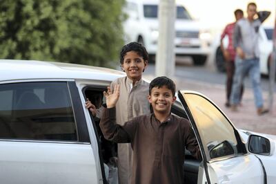 Abu Dhabi, United Arab Emirates - June 03, 2019: Two young boys smile on the day before Eid. People prepare for Eid. Monday the 3rd of June 2019. Bani Yas, Abu Dhabi. Chris Whiteoak / The National