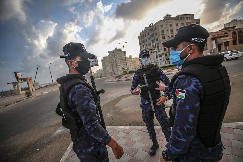 Palestinian policemen wearing face masks patrol to prevent people from gathering in front of the sea of Gaza, in the occupied Gaza City, Gaza Strip.  EPA