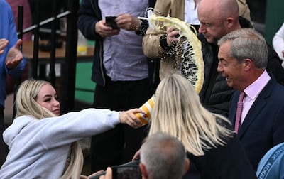 Nigel Farage has a milkshake hurled at him while campaigning in Clacton-on-Sea, Essex. AFP