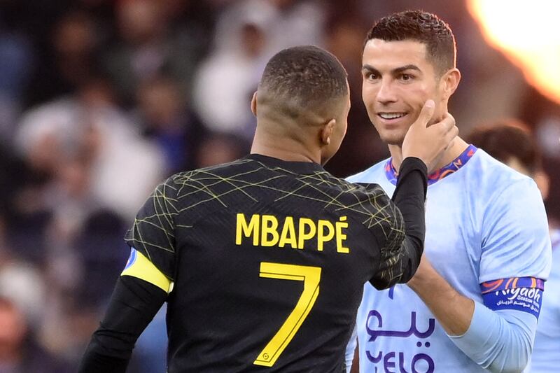 PSG's Kylian Mbappe greets Cristiano Ronaldo. AFP