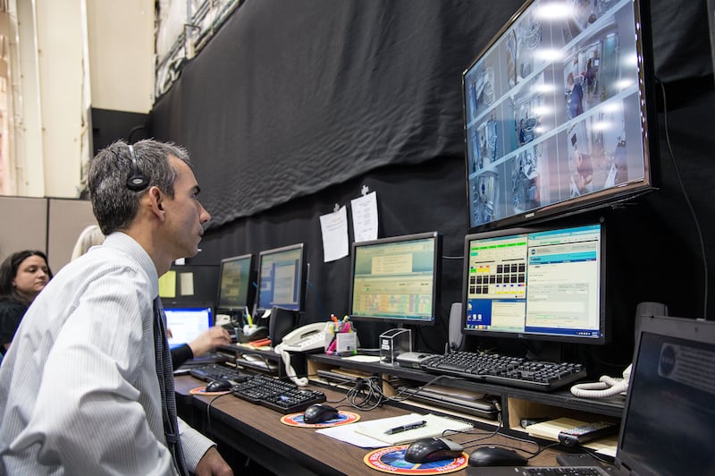 Personnel at a mission control station outside the habitat monitors the Hera crew members around the clock