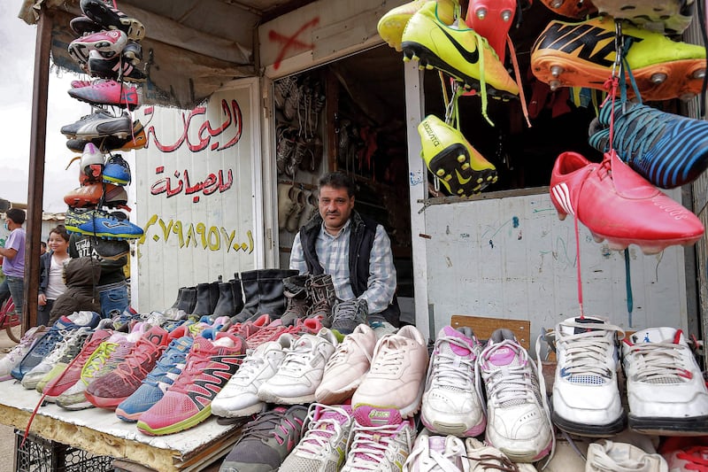A vendor at his shoe stall in the camp. AFP