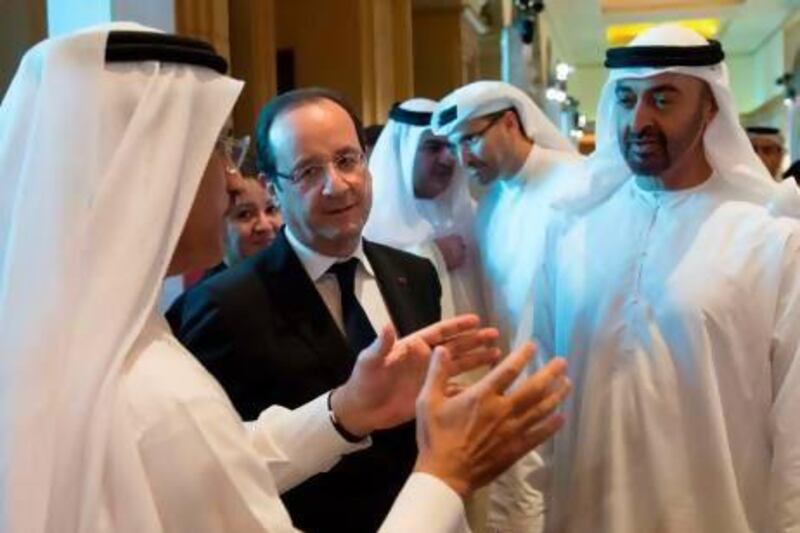 The French president Francois Hollande, centre, and Sheikh Mohammed bin Zayed, Crown Prince of Abu Dhabi and Deputy Supreme Commander of the Armed Forces, during the strategic business dialogue at the Emirates Palace yesterday. Bertrand Langois / AFP