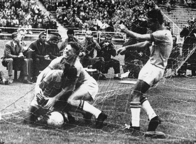 A 17-year-old Pele throws himself over the ball in the net after Brazil scored the single, winning goal of the World Cup quarter final against Wales in the 1958 World Cup. 