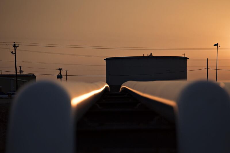 Pipelines run near oil storage tanks at the Enbridge Inc. Cushing storage terminal in Cushing, Oklahoma, U.S., on Wednesday, March 25, 2015. The fastest oil-inventory growth on record at the main U.S. hub may be about to end, easing concern that storage limits will be strained. Photographer: Daniel Acker/Bloomberg