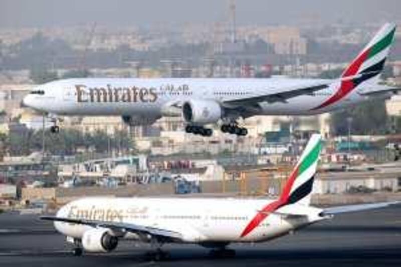 Dubai - July 29th  ,  2008 - Stock Picture of a Emirates Airlines plane landing while another  taxi's to the runway at Dubai International Airport ( Andrew Parsons  /  The National ) *** Local Caption ***  ap007-2907-dubai airport stock.jpgbz05se-meairlines.jpg