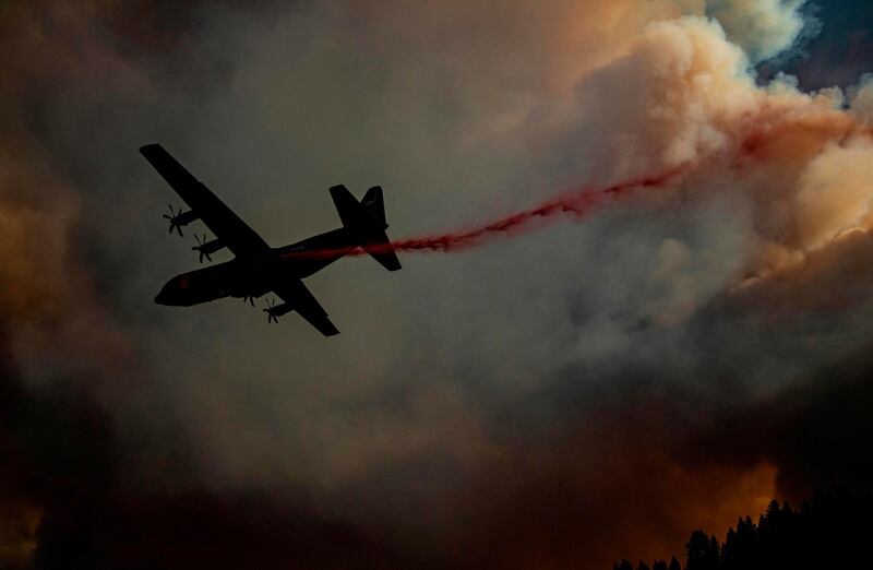 An aircraft drops fire retardant on a ridge during the Walbridge fire, part of the larger LNU Lightning Complex fire as flames continue to spread in Healdsburg. AFP