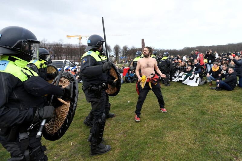 Police move towards demonstrators during a protest against coronavirus disease restrictions in The Hague, Netherlands. Reuters