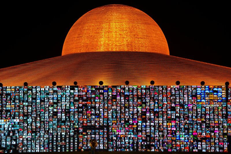 Screens at the Dhammakaya temple in Pathum Thani province, Thailand, show Buddhists gathering remotely on Zoom to mark Vesak Day, an annual celebration of Buddha's birth, enlightenment and death. Reuters