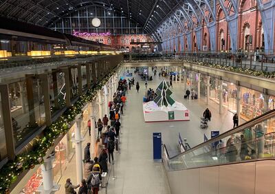 People queue to check-in for the Eurostar at St.  Pancras international train station in London, December 17. AP