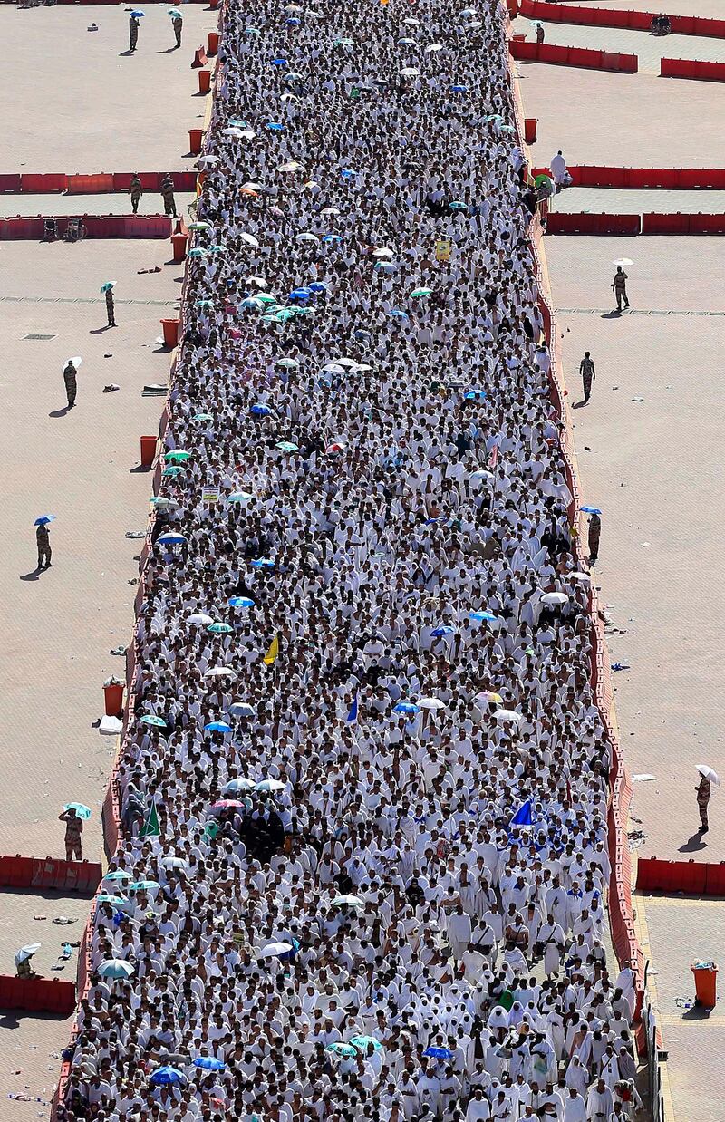 A crowd of Muslim pilgrims make their way to throw cast stones at a pillar, symbolizing the stoning of Satan, in a ritual called "Jamarat," the last rite of the annual hajj, in Mina near the Saudi holy city of Mecca, Saudi Arabia, Sunday, Nov. 6, 2011. The annual Islamic pilgrimage draws 2.5 million visitors each year, making it the largest yearly gathering of people in the world. (AP Photo/Hassan Ammar) *** Local Caption ***  APTOPIX Mideast Saudi Arabia Hajj.JPEG-0b846.jpg