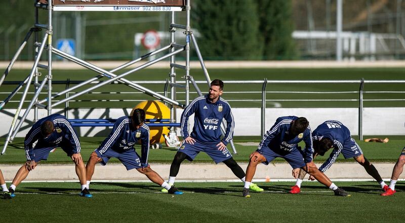 Lionel Messi stretches during a warm-up. EPA