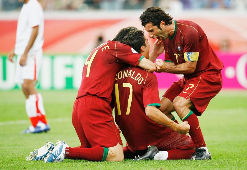 FRANKFURT, GERMANY - JUNE 17: Cristiano Ronaldo of Portugal celebrates with team mates Luis Figo (R) and Nuno Valente after scoring his team's second goal from the penalty spot during the FIFA World Cup Germany 2006 Group D match between Portugal and Iran played at the Stadium Frankfurt on June 17, 2006 in Frankfurt, Germany.  (Photo by Shaun Botterill/Getty Images)