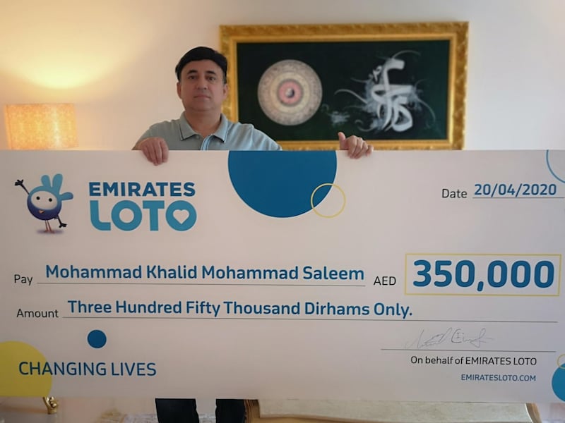 Mohammed Khalid with his cheque for Dh350,000. Courtesy: Emirates Loto