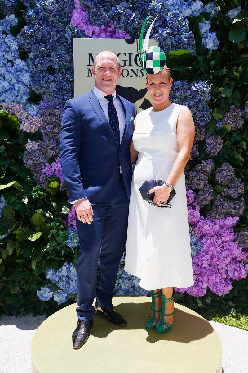 Zara Tindall, wearing a white dress with a black and green headpiece, and Mike Tindall attend the Magic Millions Raceday on January 14, 2017 in Australia. Getty Images