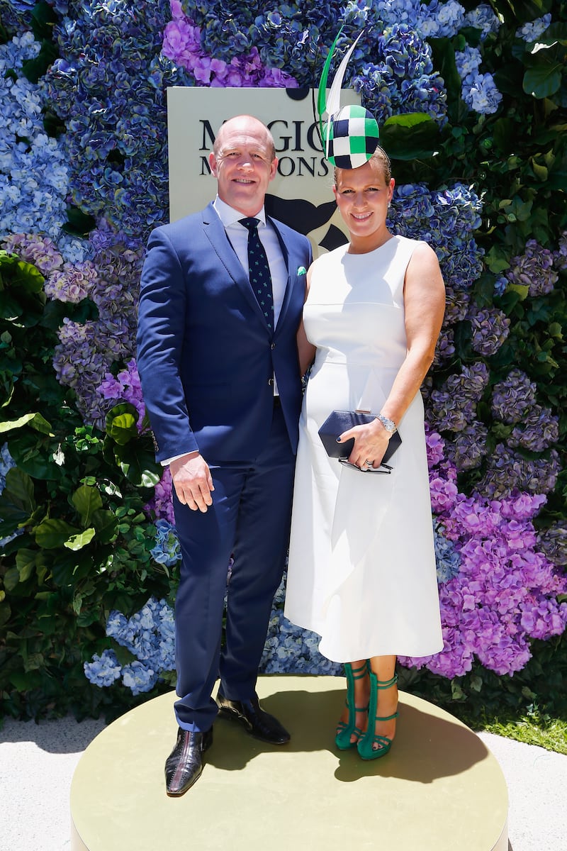 Zara Tindall, wearing a white dress with a black and green headpiece, and Mike Tindall attend the Magic Millions Raceday on January 14, 2017 in Australia. Getty Images