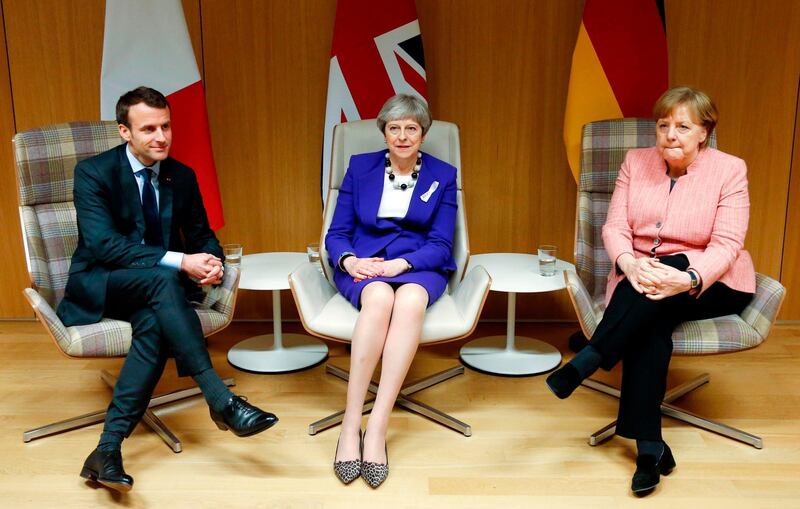 CORRECTION - British Prime Minister Theresa May (C), German Chancellor Angela Merkel (R) and French President Emmanuel Macron (L) give a press conference following a meeting on the sidelines of the European Union leaders summit in Brussels, on March 22, 2018. / AFP PHOTO / POOL / FRANCOIS LENOIR / “The erroneous mention[s] appearing in the metadata of this photo by Geert Vanden Wijngaert has been modified in AFP systems in the following manner: [FRANCOIS LENOIR] instead of [Geert Vanden Wijngaert]. Please immediately remove the erroneous mention[s] from all your online services and delete it (them) from your servers. If you have been authorized by AFP to distribute it (them) to third parties, please ensure that the same actions are carried out by them. Failure to promptly comply with these instructions will entail liability on your part for any continued or post notification usage. Therefore we thank you very much for all your attention and prompt action. We are sorry for the inconvenience this notification may cause and remain at your disposal for any further information you may require.”