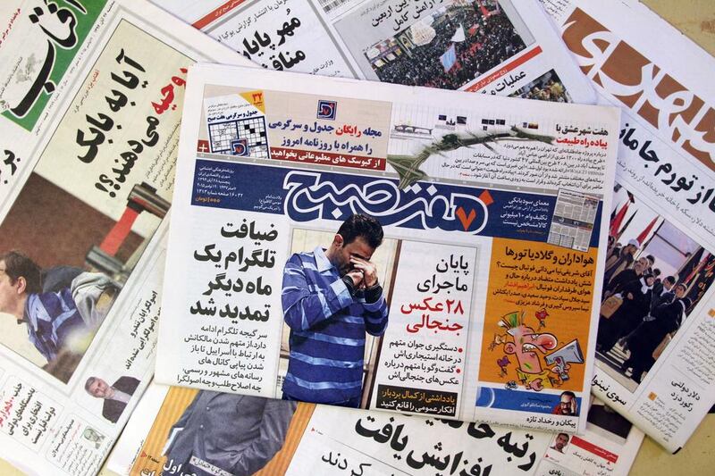 TO GO WITH AFP STORY OF ALI NOORANI A picture taken on December 6, 2015 in Tehran shows the front page of the Iranian daily "Seven Morning" reporting the detention of Vahid (picture), 30, after he shared with a phone application pictures of him surrounded by women.  Over the past eight months 609 men and 114 women have been arrested suspect of "economic, social and moral cyber crimes". AFP PHOTO / ATTA KENARE / AFP / ATTA KENARE