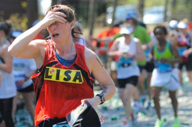 A runner feels the heat along the route of the Boston Marathon.