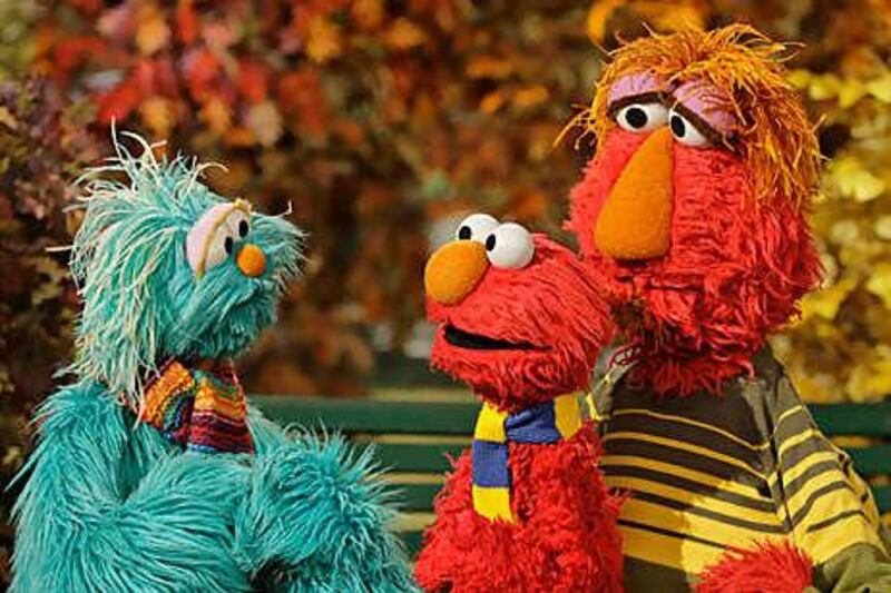 Rosita, left, talks to Elmo and his father Louie during an episode of Sesame Street.