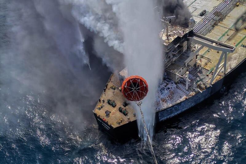 The military helicopter, coast guard ships and fireboats battle to extinguish the fire from MT New Diamond at off the east coast of Sri Lanka. EPA