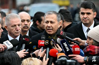 Turkish Interior Minister Ali Yerlikaya, centre, in front of Santa Maria Church after Sunday's attack. AFP