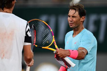 Rafael Nadal touches racquets with Egor Gerasimov following their first round match on Day 2 of the French Open. AFP