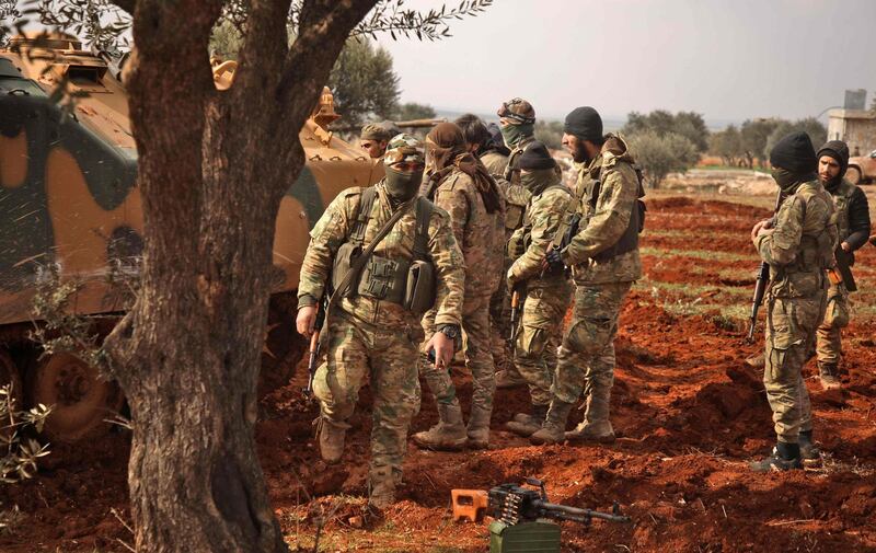 Turkish-backed Syrian fighters assemble in the village of Miznaz, on the eastern outskirts of Aleppo province, on February 14, 2020 as they prepare for a counter-offensive against advancing government forces in the Aleppo countryside.  / AFP / AAREF WATAD
