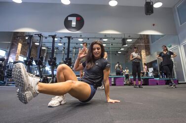 Fitness coach Holly Lohmeyer demonstrates the right form to the women exercising at GetFitChick. Leslie Pableo for The National