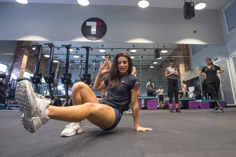 DUBAI, UNITED ARAB EMIRATES - Holly Lohmeyer, fitness coach showing the women the proper way of exercising at the GetFitChick training and nutrition group. Leslie Pableo for The National