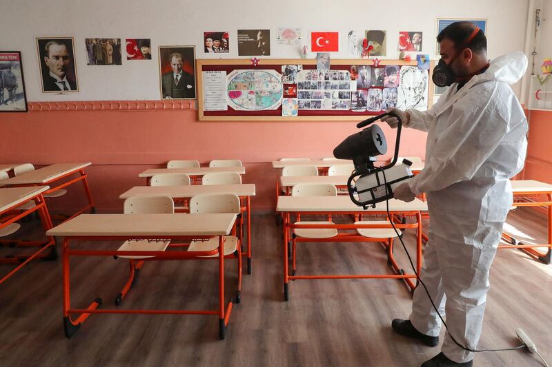 A municipal worker disinfects a classroom before pupils return to school, in Cankaya district, in Turkey's capital Ankara. AFP