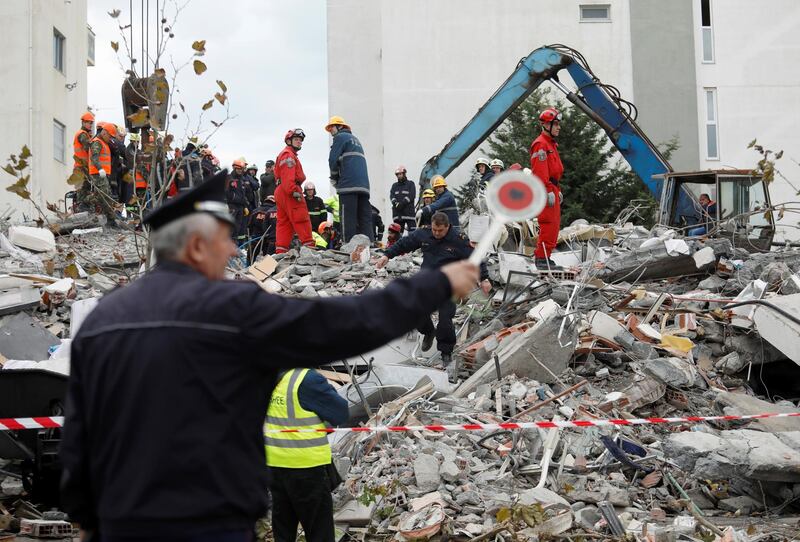 Emergency personnel search for survivors in a collapsed building in Durres. Reuters