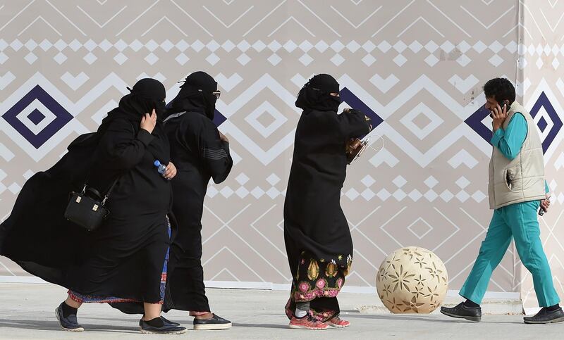 A picture taken on January 19, 2018 shows Saudi women walking during the King Abdulaziz Camel Festival in Rumah, some 160 kilometres east of Riyadh.
For decades the religious police, "mutawa" as they are known, wielded unbridled powers as arbiters of morality, patrolling streets and malls to snare women wearing bright nail polish and chastise men seeking contact with the opposite sex. In recent years, Saudi Arabia launched a series of reforms, including gradually diminishing the mutawa's powers to arrest. Crown Prince Mohammed bin Salman has further cut back the political role of hardline clerics in a historic reordering of the Saudi state.
 / AFP PHOTO / FAYEZ NURELDINE