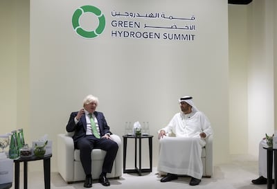 Former British prime minister Boris Johnson, left, with Dr Sultan Al Jaber, Minister of Industry and Advanced Technology, and the President of Cop28. EPA
