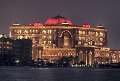 Abu Dhabi, United Arab Emirates - July 22, 2019: Emirates Palace hotel is lit up in red to celebrate Sheikh Mohamed bin Zayed's visit to China. Monday the 22nd of July 2019. Corniche, Abu Dhabi. Chris Whiteoak / The National
